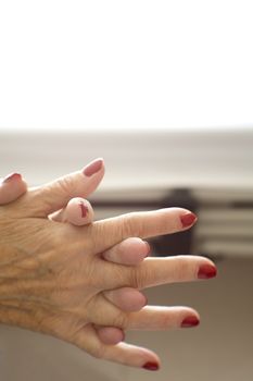 Hands of old woman and elderly caregiver