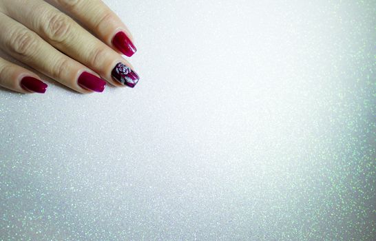 Female manicure in red tones. Copy space