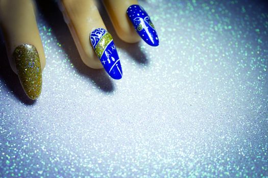 Permanent gel nails with new year decoration.  Bright background