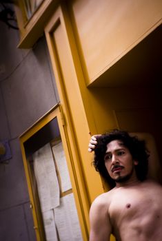 Portrait of latin man with beard and curly black hair. Naked torso