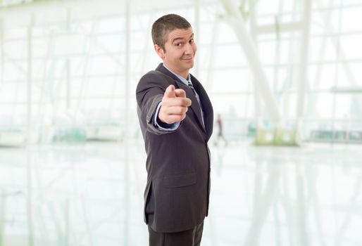 happy business man pointing, at the office