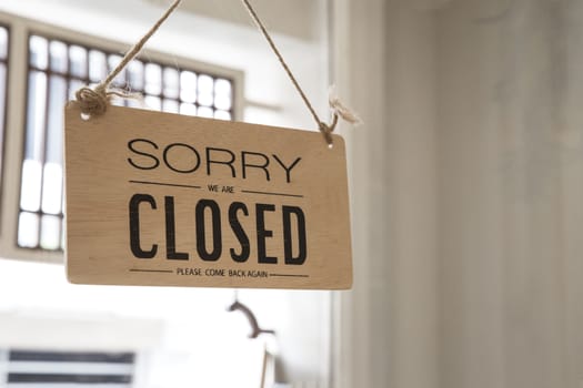 Close up of the sign board "Closed" shop or cafe of the window at the door