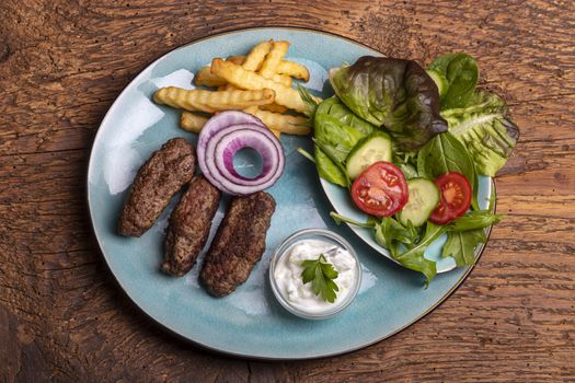 cevapcici with french fries and salad