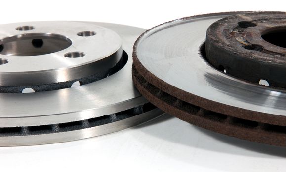 Two brake discs for the car, one new, one old