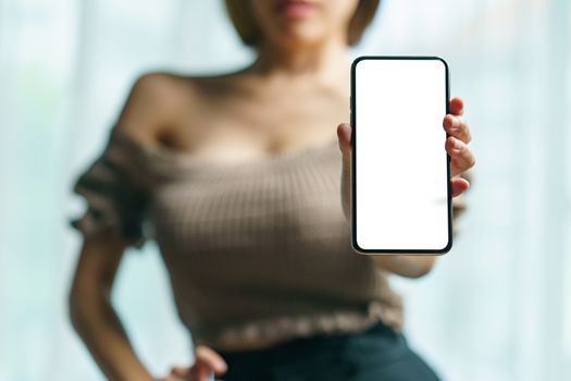 Sexy woman showing white blank display of her mobile phone.
