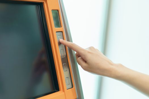 Woman finger pressing a button of Automated Teller Machine( ATM )