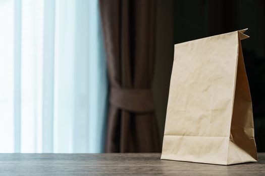 Recycle brown paper bag on a wooden table.
