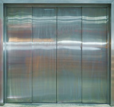 Front view of silver metal elevator with closed doors.