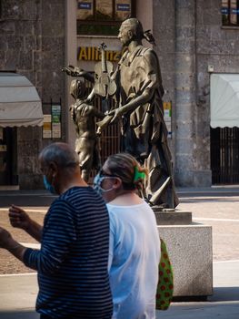 Cremona, Lombardy, Italy - May  5 6 7  2020 - man or woman walking or biking in deserted downtown  during covid outbreak lockdown phase 2
