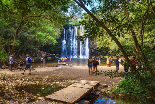 Bagaces, Costa Rica - January 17, 2020 : People enjoy playing and swimming at Llanos the Cortes waterfall in Bagaces