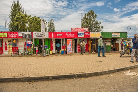 NAIVASHA, KENYA - OCTOBER 18, 2014: Typical shopping street scene with pedestrians in Naivasha, Kenya.