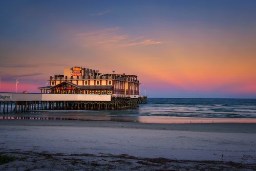 Daytona Beach, Florida, USA - January 8, 2020: Sunset above Daytona Beach Main Street Pier With Joe's Crab Shack restaurant.