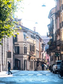 Cremona, Lombardy, Italy - May  5 6 7  2020 - man or woman walking or biking in deserted downtown  during covid outbreak lockdown phase 2