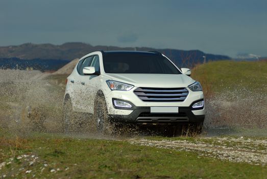 suv drives through flooded road