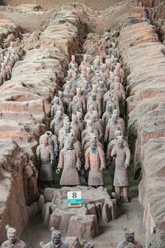 Xian, China - May 1, 2010: Terracotta Army museum and hall.  Trench packed with gray-beige soldier sculptures at excavation.