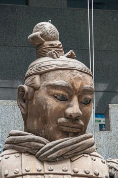 Xian, China - May 1, 2010: Terracotta Army museuml.  face closeup of Giant light brown sculpture of officer in style. wall as backdrop.