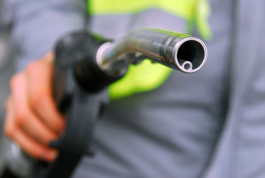 look askance at the hand holding the gas nozzle