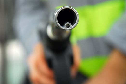 look askance at the hand holding the gas nozzle