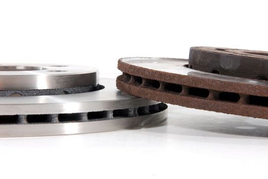 Two brake discs for the car, one new, one old