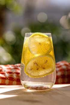 Citrus lemonade in garden setting, summer drink.