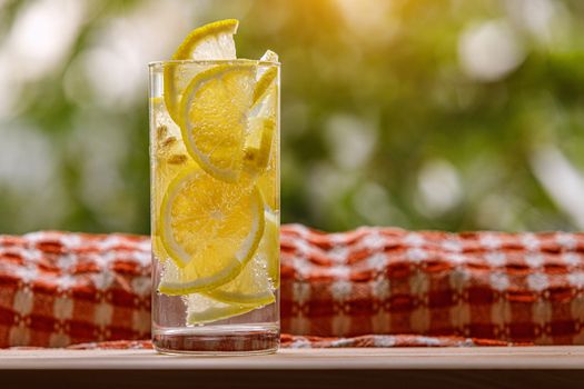 Citrus lemonade in garden setting, summer drink.