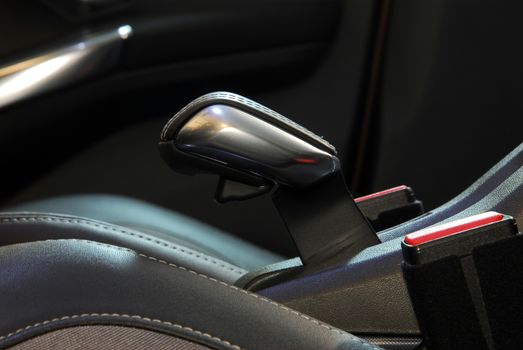 Close view of car handbrake, inside car