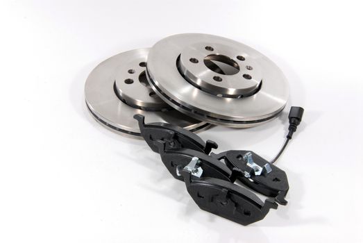 four brake pads and two new brake discs for the car