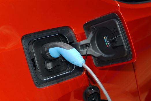 Close up of the power supply plugged into an electric car being charged