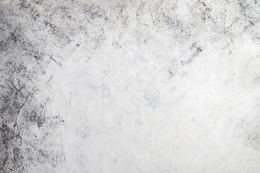 Concrete white gray background with scuffs and black splashes. Textured wall texture in the grunge style.