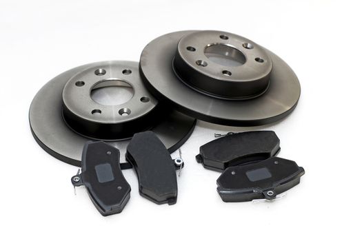four brake pads and two new brake discs for the car
