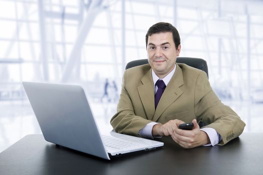 happy businessman working with is laptop at the office