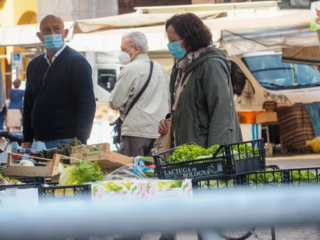 Cremona, Lombardy, Italy - 16 th may 2020 - People grocery shopping socially distance d in local biologic open air  food market wearing protection facial mask to prevent against contagion of coronavirus infection disease