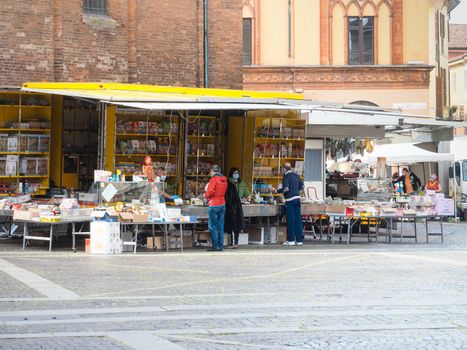 Cremona, Lombardy, Italy - 16 th may 2020 - People grocery shopping socially distance d in local biologic open air  food market wearing protection facial mask to prevent against contagion of coronavirus infection disease