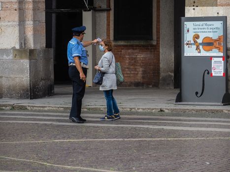 Cremona, Lombardy, Italy - 16 th may 2020 - People grocery shopping socially distance d in local biologic open air  food market wearing protection facial mask to prevent against contagion of coronavirus infection disease