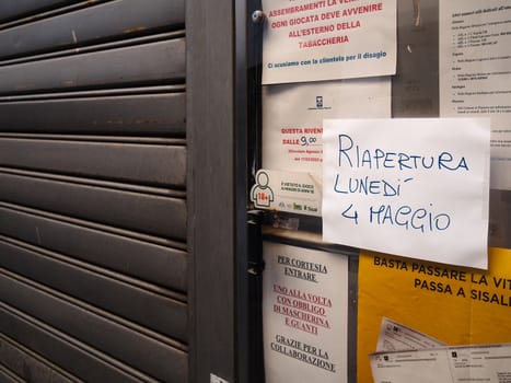 Cremona, Lombardy, Italy - April 30 th - May 1st 2020 - closed bars  and general commerce  during coronavirus lockdown and economic crisis. Italian signs