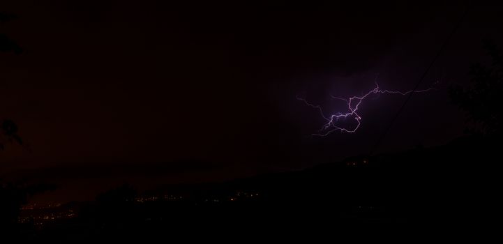 Lightning bolts during an evening thunderstorm over Geres National Park, Amares, Portugal