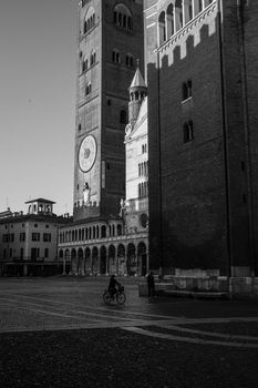 Cremona, Lombardy, Italy - April 30 th - May 1st 2020 - people biking walking dog walking in the center during covid 19  lockdown and economic crisis in Lombardy affected region.