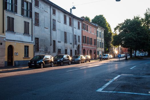 Cremona, Lombardy, Italy - April 30 th - May 1st 2020 - people biking walking dog walking in the center during covid 19  lockdown and economic crisis in Lombardy affected region.