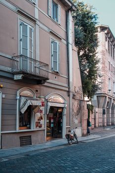 Cremona, Lombardy, Italy - April 30 th - May 1st 2020 - people biking walking dog walking in the center during covid 19  lockdown and economic crisis in Lombardy affected region.