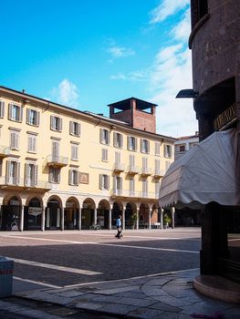 Cremona, Lombardy, Italy - April 30 th - May 1st 2020 - people biking walking dog walking in the center during covid 19  lockdown and economic crisis in Lombardy affected region.