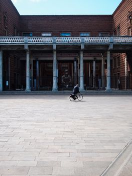 Cremona, Lombardy, Italy - April 30 th - May 1st 2020 - people biking walking dog walking in the center during covid 19  lockdown and economic crisis in Lombardy affected region.