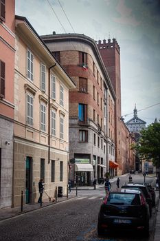 Cremona, Lombardy, Italy - April 30 th - May 1st 2020 - people biking walking dog walking in the center during covid 19  lockdown and economic crisis in Lombardy affected region.