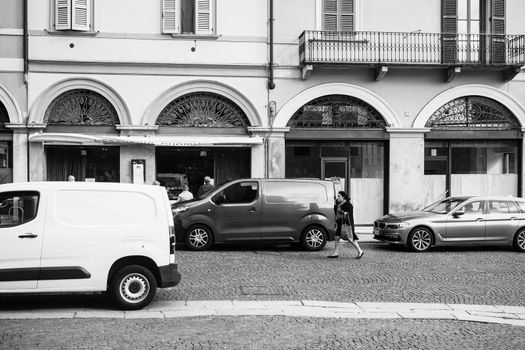 Cremona, Lombardy, Italy - April 30 th - May 1st 2020 - people biking walking dog walking in the center during covid 19  lockdown and economic crisis in Lombardy affected region.