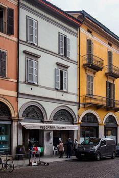 Cremona, Lombardy, Italy - April 30 th - May 1st 2020 - people biking walking dog walking in the center during covid 19  lockdown and economic crisis in Lombardy affected region.