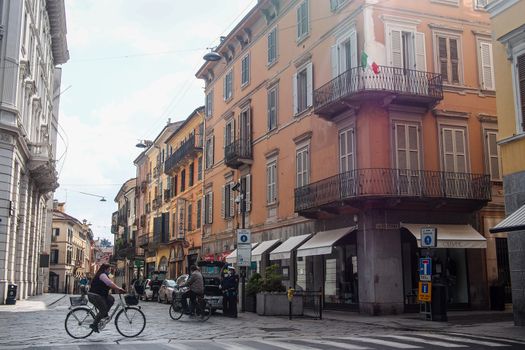 Cremona, Lombardy, Italy - April 30 th - May 1st 2020 - people biking walking dog walking in the center during covid 19  lockdown and economic crisis in Lombardy affected region.