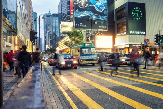 HONG KONG - JANUARY 14: People speed walking across Road, Causeway Bay in front of a big department store at Daylight. Hong Kong January 14, 2016