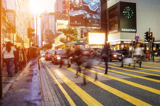 HONG KONG - JANUARY 14: People walking across Road, Causeway Bay in front of a big department store at Daylight. Hong Kong January 14, 2016