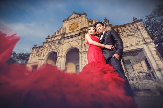 Man in black suit and Beautyful woman wearing fashionable red dress