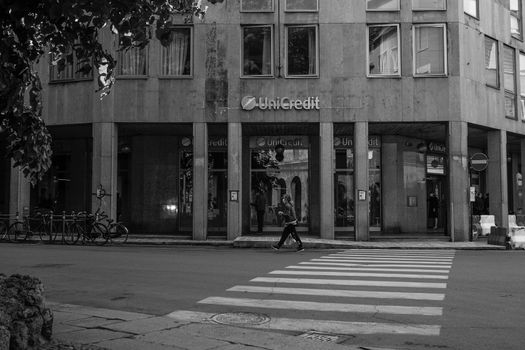 Cremona, Lombardy, Italy - April 30 th - May 1st 2020 - people biking walking dog walking in the center during covid 19  lockdown and economic crisis in Lombardy affected region.