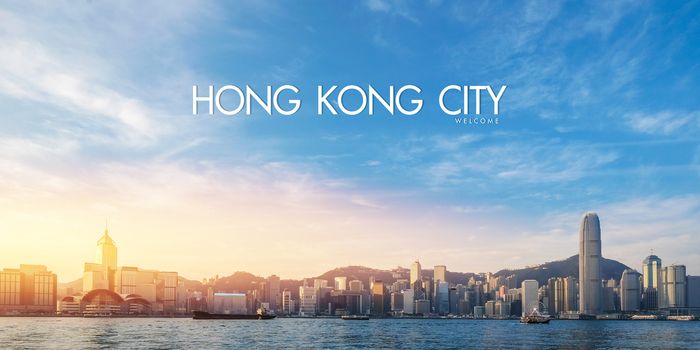 Hong Kong's Victoria Harbour in sunrise with text welcome to Hong Kong City